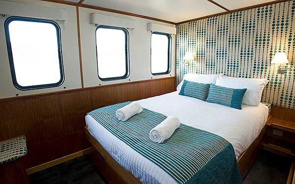 On the top deck, this 8.5 meter Square Cabin is complete with double bed, 26" TV, wardrobe and Writing Desk