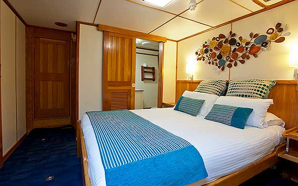 On the Lower Deck, this 9.2 meter Square Cabin is in a private area complete with queen size bed and extra shelving